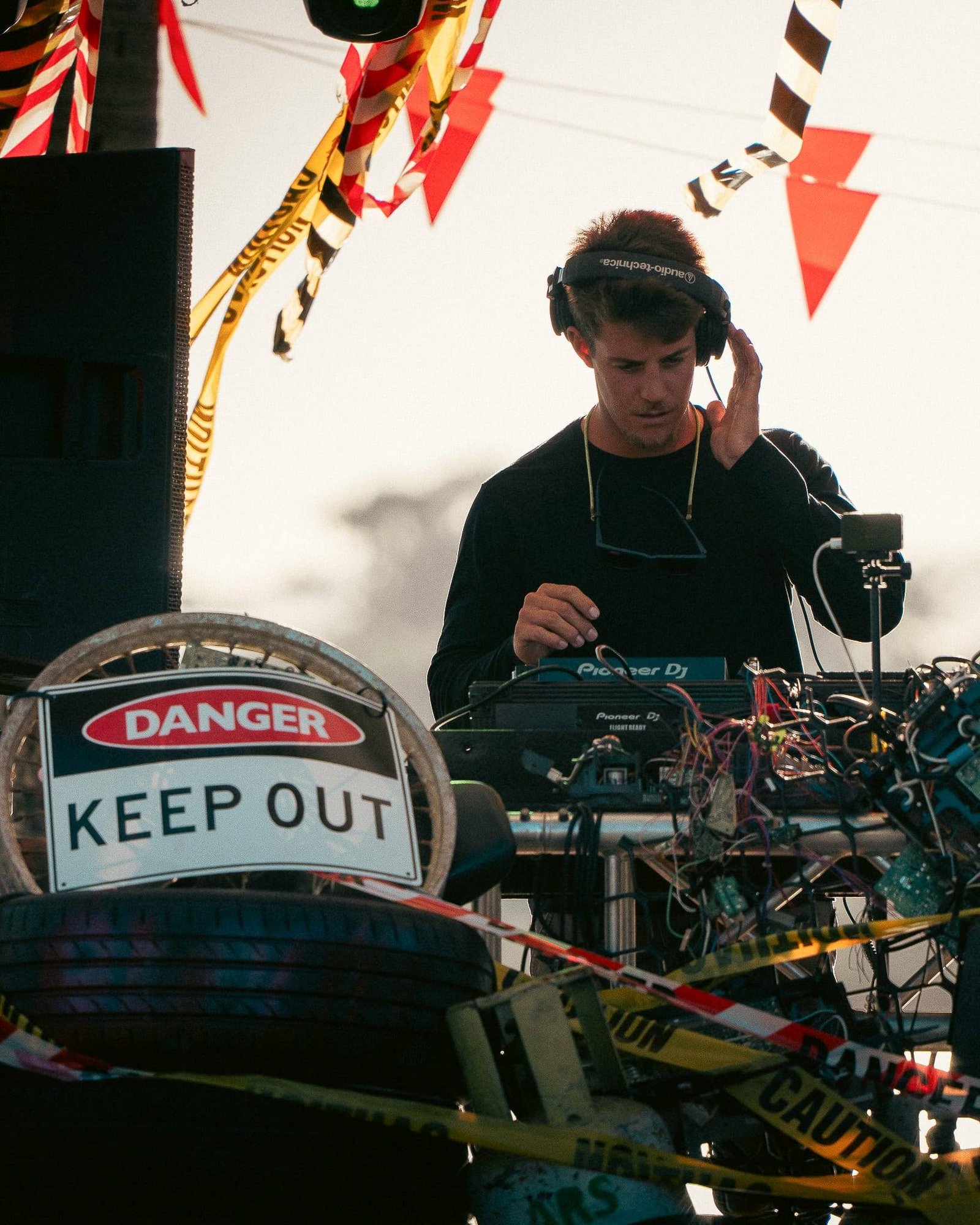 A DJ playing outdoors in late-afternoon light